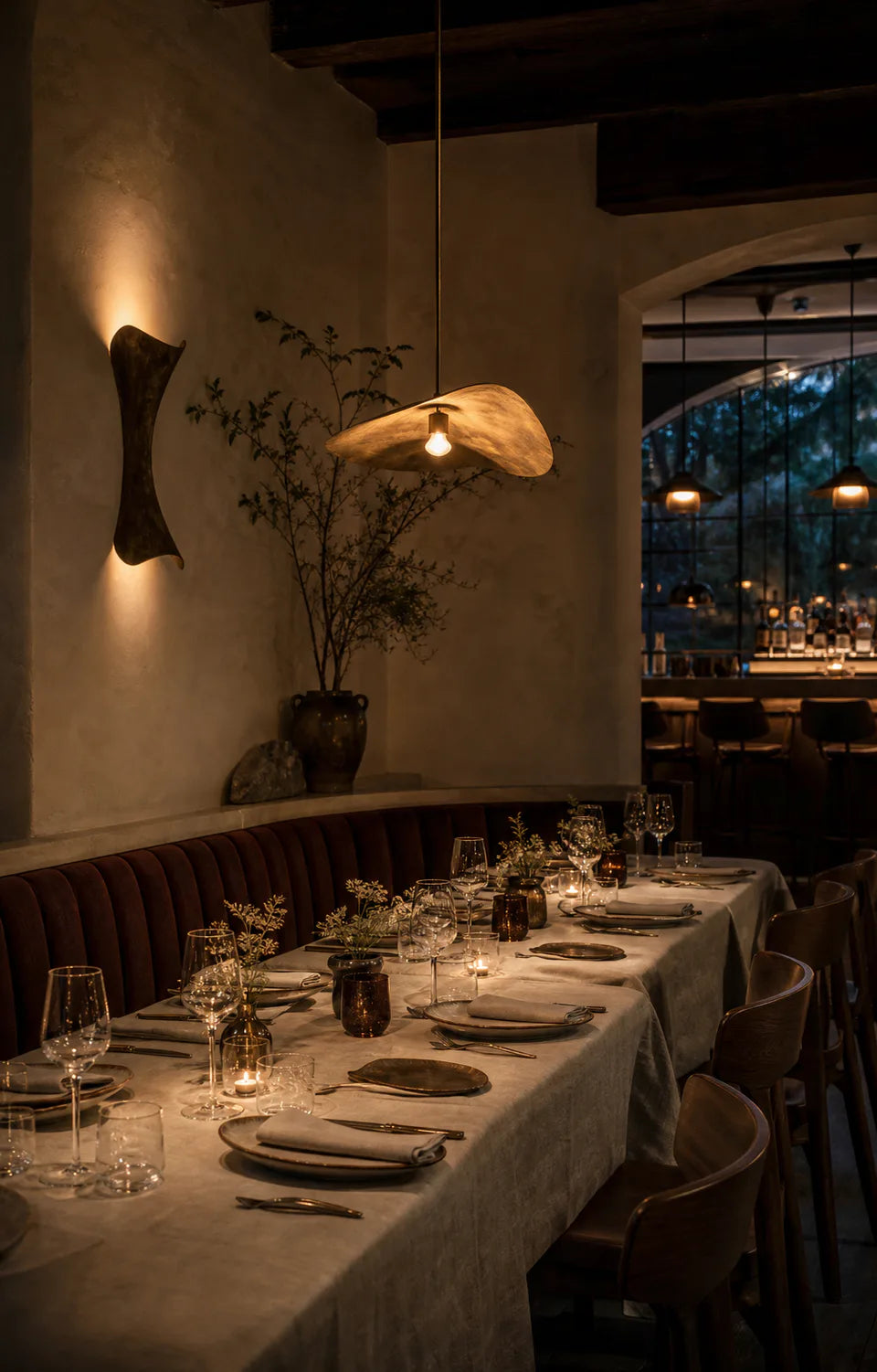 A warmly lit restaurant table prepared for evening service