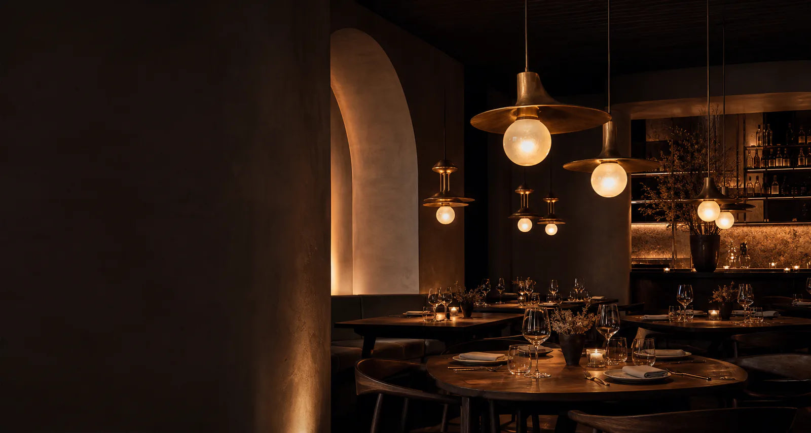 Warm brass pendant lights illuminating an intimate restaurant dining room
