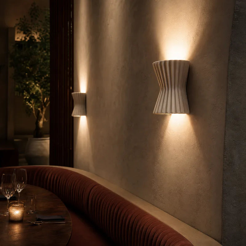 Ceramic wall sconces lighting a restaurant booth